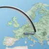 A symbolic illustration of a boomerang flying over a stylized map of Europe, curving back towards the West, with subtle visual cues of media influence such as faint broadcast waves or microphones integrated into the background, conveying the idea of a reversed impact or backlash without any literal text or logos.