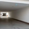 A wide shot of a newly cleaned underground passage in Vladikavkaz. The walls are smooth and clean, showing the original architectural details. Sunlight streams in from the entrance, illuminating the passage. Focus on the cleanliness and the architectural features of the underpass.