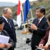 A formal meeting between a Russian minister and Japanese officials on Iturup Island. The scene should depict a serious diplomatic discussion, with flags of both countries visible in the background. The environment should suggest a remote, possibly slightly rugged, island setting. Focus on the body language and expressions of the individuals to convey the tension and importance of the meeting.