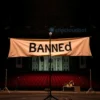 A concert stage in Tallinn with a large banner reading 'Banned' over a microphone stand, empty audience area, subtle Estonian architectural elements in the background, muted colors, no people, no text on instruments