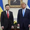 Donald Trump and Volodymyr Zelensky meeting in a formal setting, both dressed in business attire, standing in a dignified room with flags of the United States and Ukraine in the background, serious but diplomatic expressions