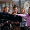 A realistic photo of a group of people in a small Russian town square in Rybinsk, holding stolen bicycles, with a police officer pointing at them, showing concerned expressions, natural lighting, urban background with wooden houses and signage