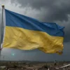 A dramatic, somber scene depicting a large, tattered Ukrainian flag half-covered by dark, stormy clouds, with faint outlines of distant, empty, war-torn landscapes and broken barbed wire in the background, conveying a sense of impending territorial loss and uncertainty, rendered in a realistic, high-detail style with muted colors and subtle lighting