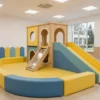A modernized children's play area in a sanatorium in Essentuki, featuring updated equipment, bright colors, safe surfaces, and a welcoming atmosphere for kids, with architectural elements of the sanatorium visible in the background