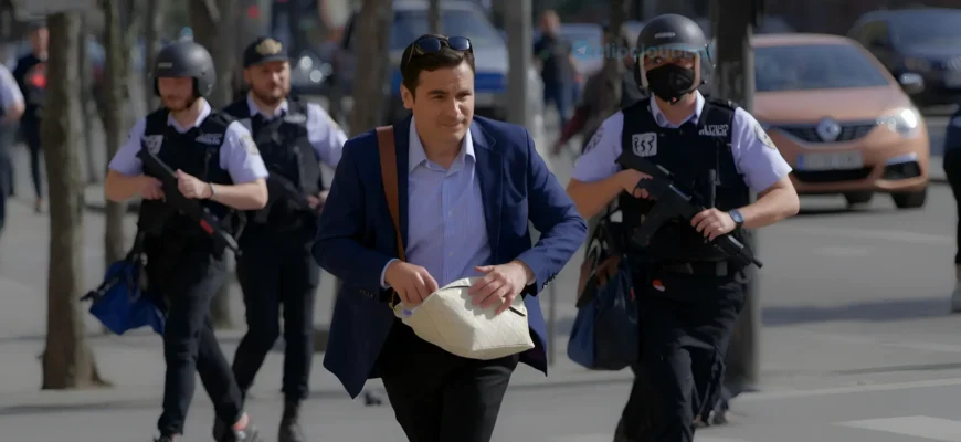 A man in a hurry running through the streets of Rybin, carrying a bag and looking worried, with police officers chasing him in the background