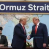 A political scene depicting Donald Trump in a formal setting, shaking hands with Iranian officials, with a large sign in the background reading 'Ormuz Strait' and a map of the region visible, symbolizing a diplomatic agreement involving the strait