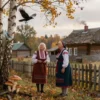 A traditional Russian village scene on September 2nd, showing elderly women in folk costumes observing nature: a crow flying low over a birch tree, mushrooms growing near an old oak, and a spiderweb glistening with morning dew on a fence. In the background, a wooden house with a thatched roof and smoke rising from the chimney. Soft golden autumn light, realistic details, no text or symbols.